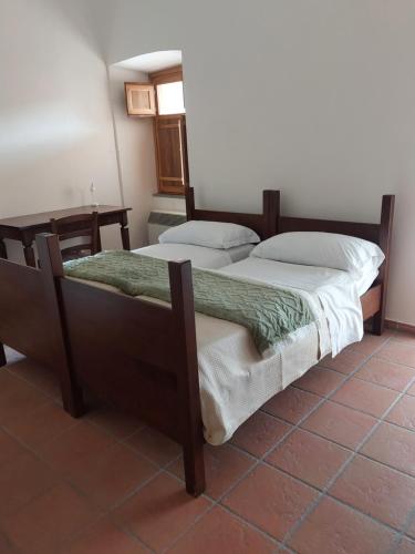 two twin beds in a room with at BB Convento Sant Antonio di Laurino in Laurino