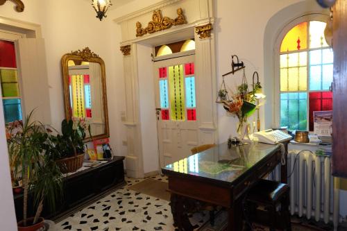 a room with a desk and stained glass windows at Hotel Villa Nettuno in Taormina