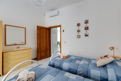a bedroom with two beds and a dresser at Casa Miriam in Oristano