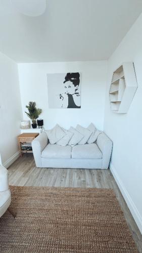 a white living room with a white couch in a room at Southsea HomeStays - Three Bedroom Home, Sleeps 8 - with Garden & Hot Tub in Portsmouth
