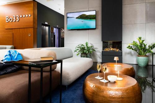 a living room with a couch and a fireplace at Bo33 Hotel Family & Suites in Budapest