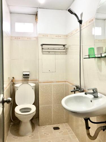 a bathroom with a toilet and a sink at Seven Stars Hotel in Ho Chi Minh City