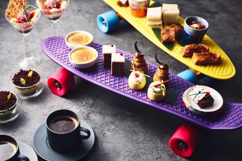 a table with a tray of desserts and cups of coffee at Hotel Indigo Tokyo Shibuya in Tokyo