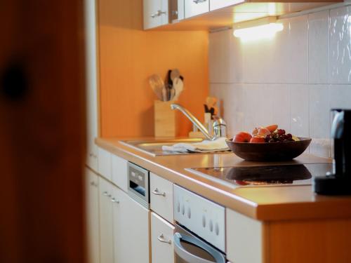a kitchen with a bowl of fruit on the stove at ERLEBNISBAUERNHOF Steinerhof in Kärnten in Liebenfels