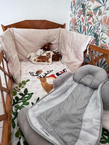 a dog laying on a bed in a crib at Le seventie's in Millau