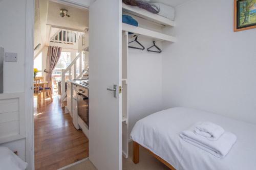 a small bedroom with a bed and a kitchen at Chalet Eightyone in Deal