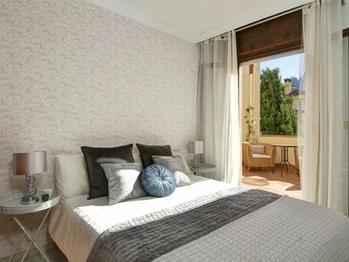 a bedroom with a large bed and a balcony at Chezmoihomes Alhambra Penthouse 2 private terraces in Granada