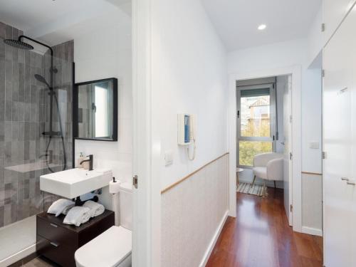 a white bathroom with a sink and a mirror at San Anton Boutique Terrace in Granada