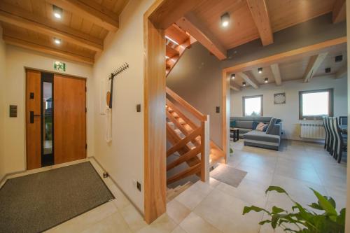 a hallway with a staircase and a living room at Widokówka Koniaków in Koniaków