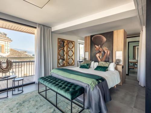 a bedroom with a bed and a large window at Luxury Alhambra Penthouse Collection in Granada