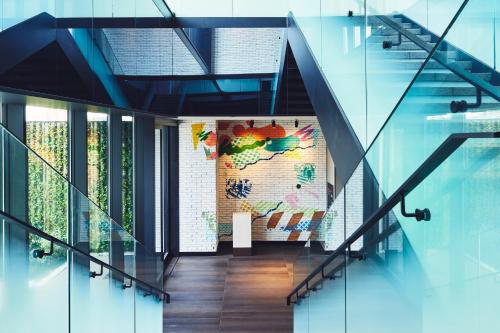 a staircase in a building with glass walls at Hotel Indigo Tokyo Shibuya in Tokyo