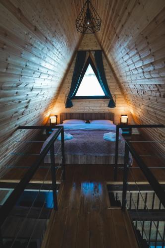 a bedroom with a bed in a room with a window at Sanseco Cottage in Stepantsminda
