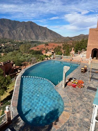 a swimming pool with a view of the mountains at KASBAH LA DAME BIJA in Tassa Ouirgane