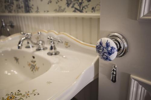 a bathroom with a white sink with a blue and white pattern at The Chanler at Cliff Walk in Newport