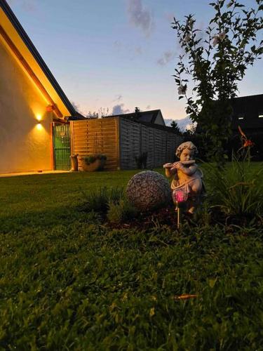 a teddy bear sitting in the grass in a yard at Idyllic holiday home - relaxation place in Leibnitz