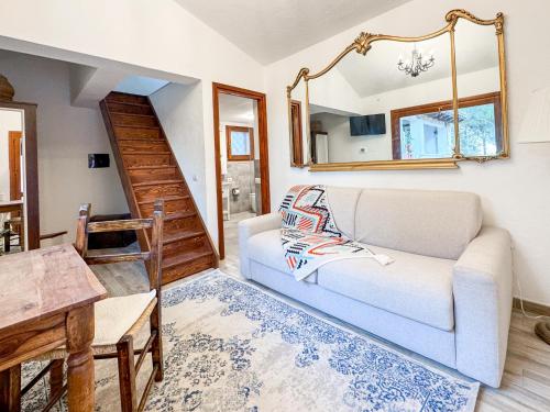 a living room with a white couch and a table at Villa La Petite Etoile in Torre delle Stelle