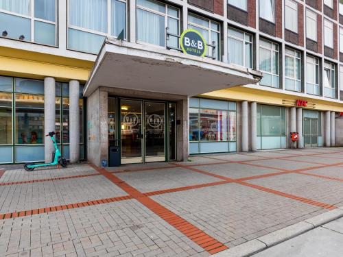 a store front of a building with a mop outside at B&B HOTEL Bochum-Hbf in Bochum