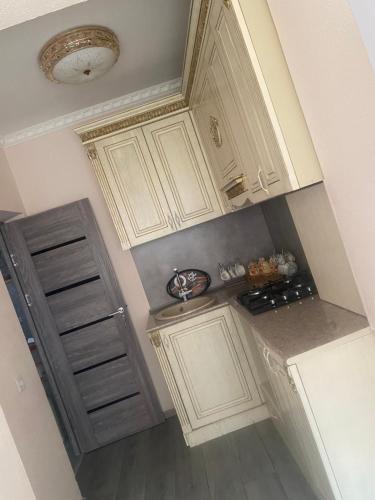an overhead view of a kitchen with white cabinets at Нара in Gyumri
