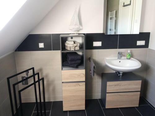 a bathroom with a sink and a mirror at Ferienhaus Melody in Ralswiek