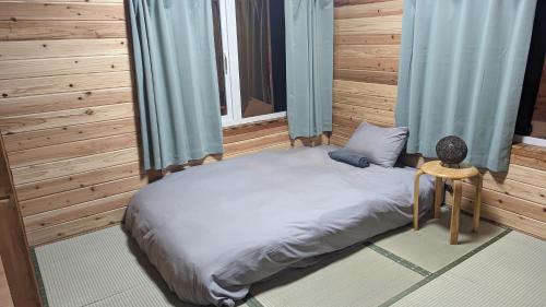 a large bed in a room with a window at Yukiumi Furano in Furano