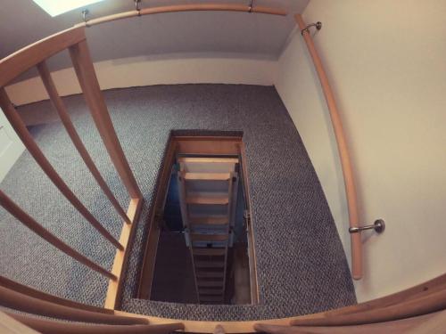 a spiral staircase with a ladder in a room at Ferienhaus Melody in Ralswiek