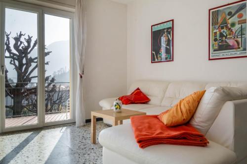 a living room with a white couch and a table at Enjoy Lenno in Lenno