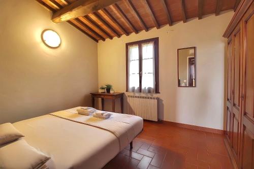 a bedroom with a bed and a window at Corte Tommasi Residence in Orentano