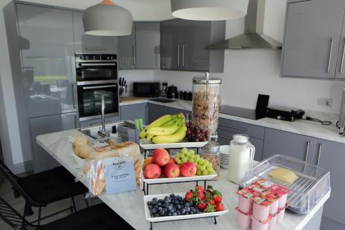 a kitchen with three trays of fruit on a counter at Causeway guest accommodation in Bushmills