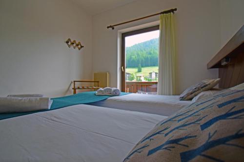 Postel nebo postele na pokoji v ubytování Hotel Comelico