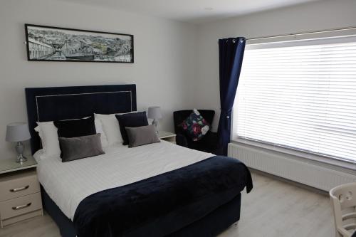 a bedroom with a large bed and a window at Causeway guest accommodation in Bushmills