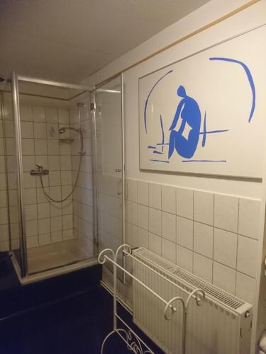 a bathroom with a shower and a sign on the wall at Im kurfürstlichen Zollamt in Tangermünde