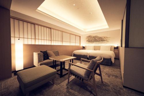 a hotel room with two beds and a couch at Richmond Hotel Premier Kyoto Ekimae in Kyoto