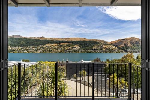 a view of a lake from a balcony at Luxurious Lake View Escape in Frankton Wharf