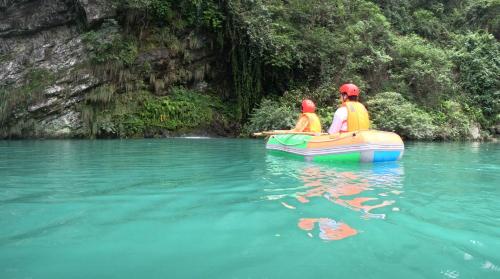 two people are in a raft in the water at Valley Oasis Villa in Enshi