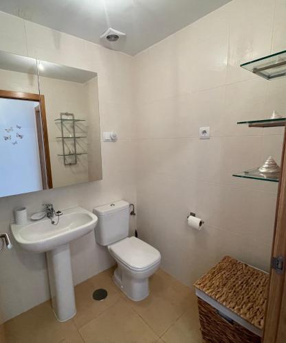 a bathroom with a white toilet and a sink at Condado de Alhama, LA ISLA 80H in El Romero