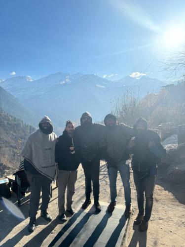 a group of people standing on top of a mountain at Cafekush tosh in Tosh