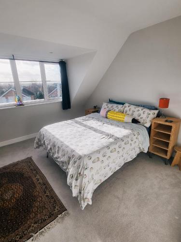 a bedroom with a bed and two windows at Private room in townhouse near Heathrow & Windsor in Burnham