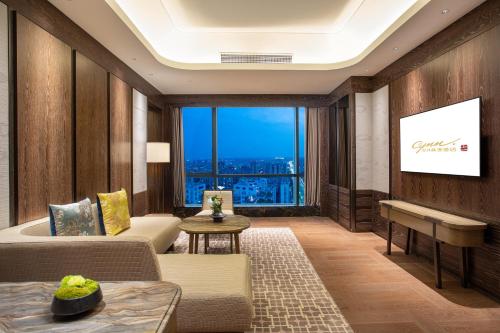 a living room with a couch and a piano at CYNN XANADU Hotel Chengdu in Chengdu