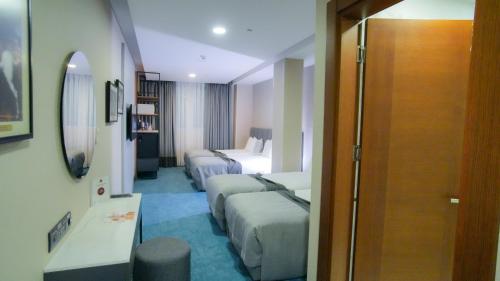 a hotel room with two beds and a bedroom at Dosso Dossi Hotels Old City in Istanbul