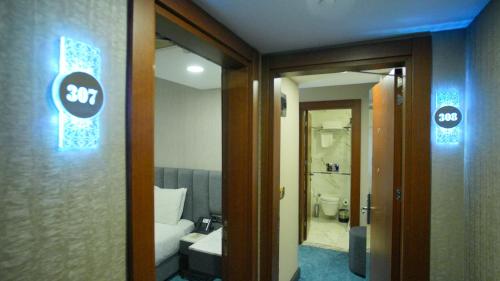 a room with a bathroom with a toilet and a door at Dosso Dossi Hotels Old City in Istanbul
