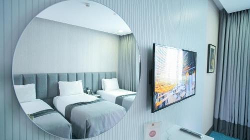 a room with two beds and a mirror at Dosso Dossi Hotels Old City in Istanbul