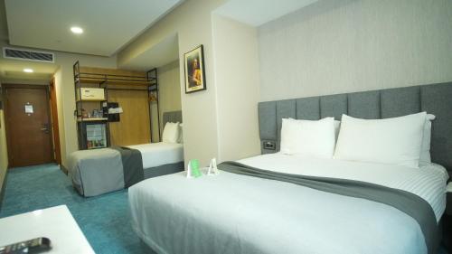 a hotel room with a large bed and a desk at Dosso Dossi Hotels Old City in Istanbul