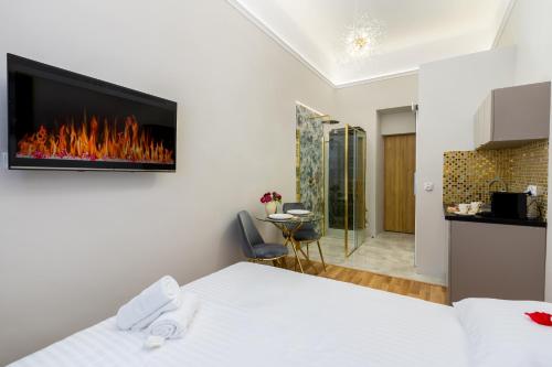 a bedroom with a bed with a fireplace on the wall at Jacuzzi Berka Apartamenty in Krakow