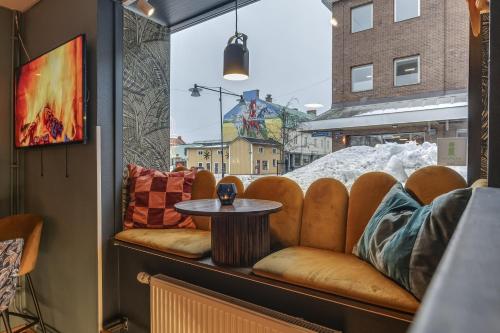a room with a table and chairs and a window at Best Western Plus Grand Hotel Elektra in Ludvika