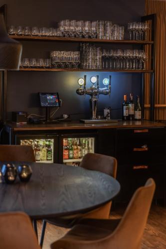 a bar with a table and chairs in a room at Best Western Plus Grand Hotel Elektra in Ludvika