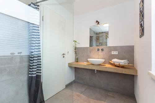 a bathroom with a sink and a mirror at Boardinghouse in Bad Reichenhall