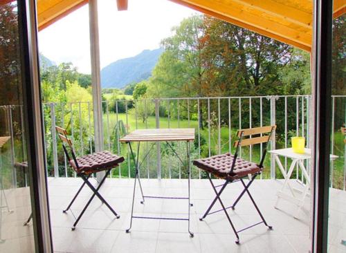 a patio with two chairs and a table on a balcony at Boardinghouse in Bad Reichenhall