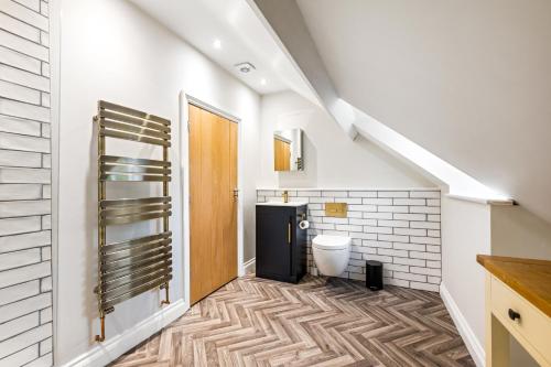 a bathroom with a toilet and a staircase at 32 Bailgate, Lincoln in Lincolnshire