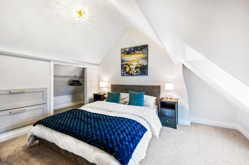 a bedroom with a large bed with blue pillows at 32 Bailgate, Lincoln in Lincolnshire