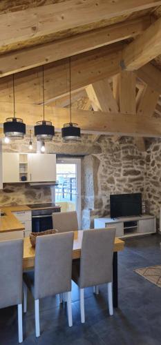 a dining room with a wooden table and chairs at Casa do Rio - AL in Valença